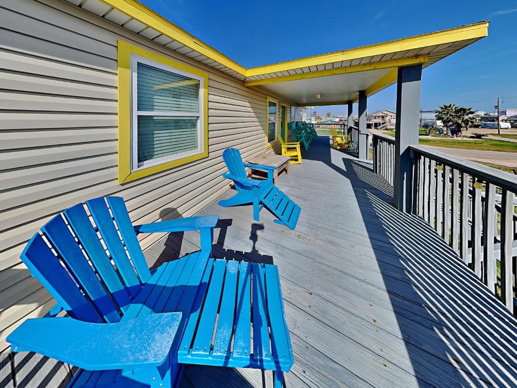 two blue chairs sitting on the porch of a house at Beachy Keen in Surfside