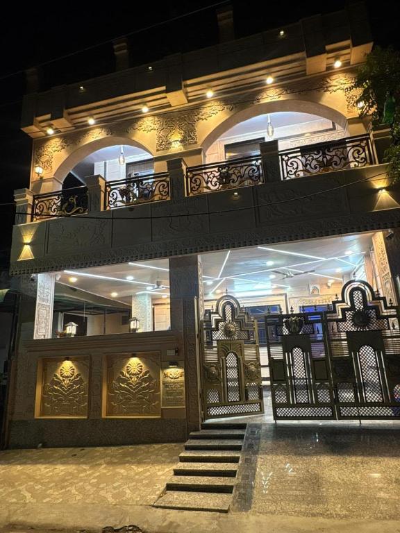 a building with a balcony and stairs in front of it at Riddhihomestay in Jaipur