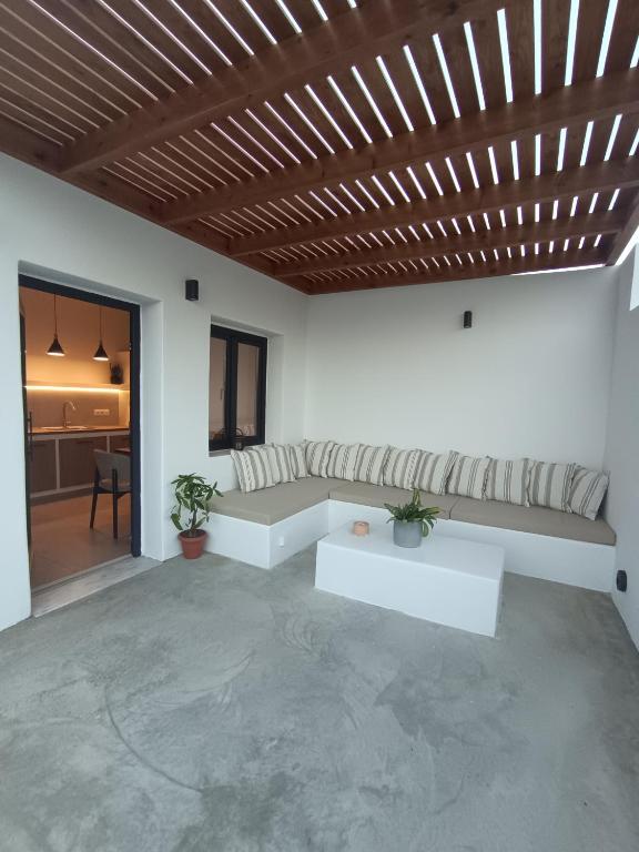 a living room with a couch and a table at IOVI Tinos II in Agios Sostis