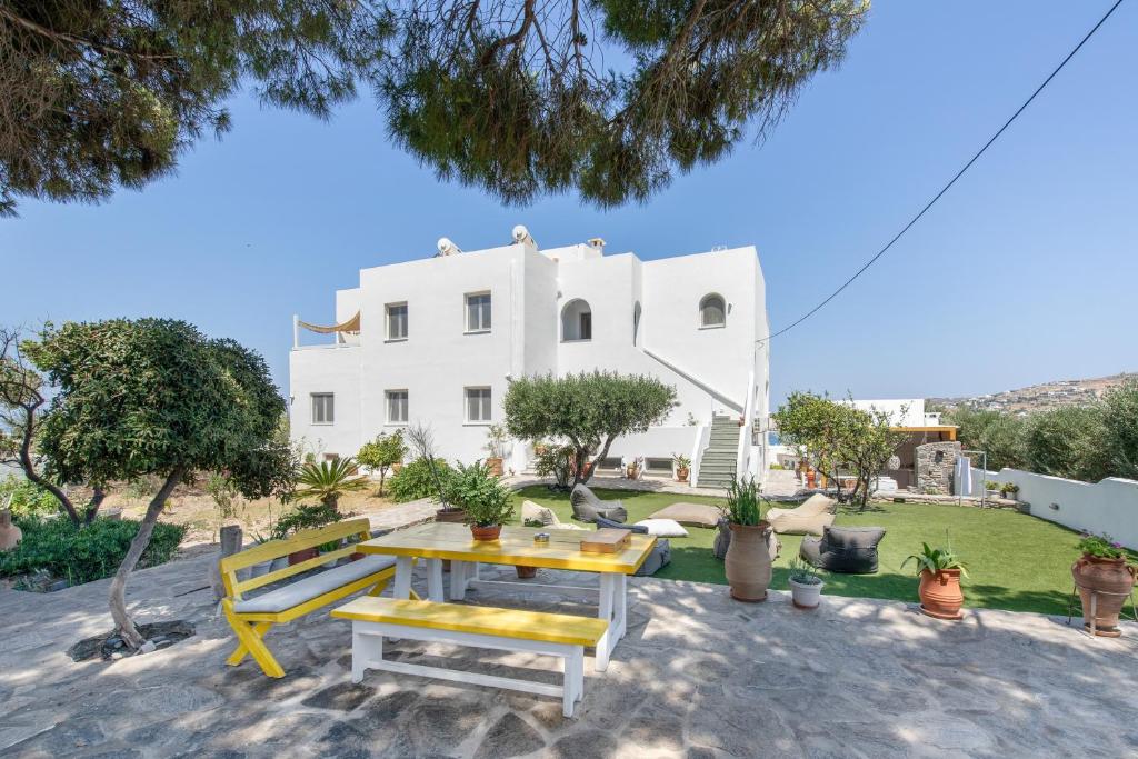 a table and bench in front of a white house at Crystal Dream Paros in Kampos Paros