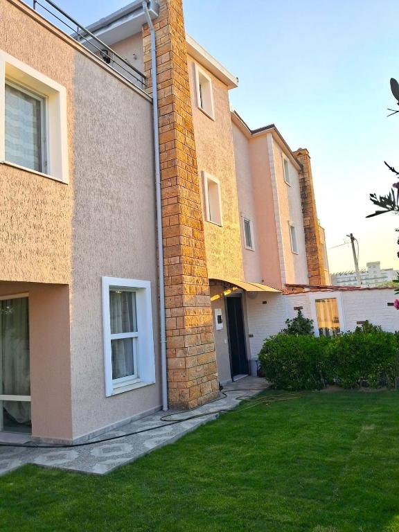 a group of buildings with a grass yard at Sea View Villa w Garden 50m to Sarımsaklı Beach in Ayvalık