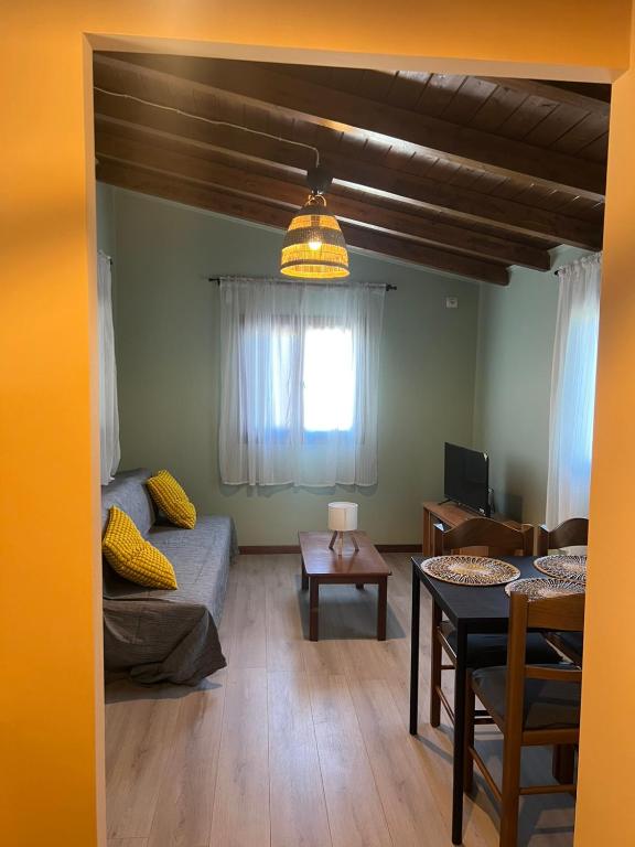 a living room with a couch and a table at Amarynthos Tiny Retreat in Amarynthos