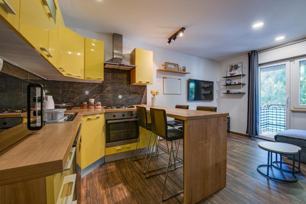 a kitchen with yellow cabinets and a counter top at Apartment Niksa in Pula