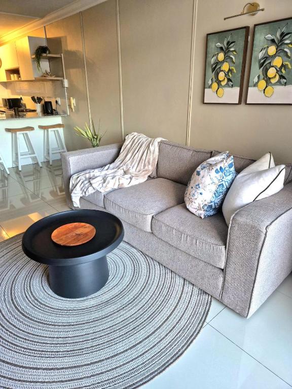 a living room with a couch and a coffee table at Fortune Lux - Tygerwaterfront in Tyger Valley