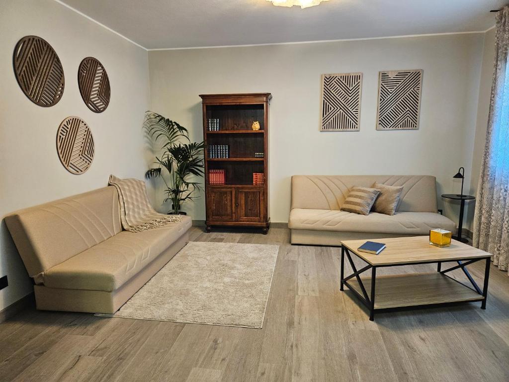 a living room with two couches and a coffee table at EdenGHouse in Cordenons