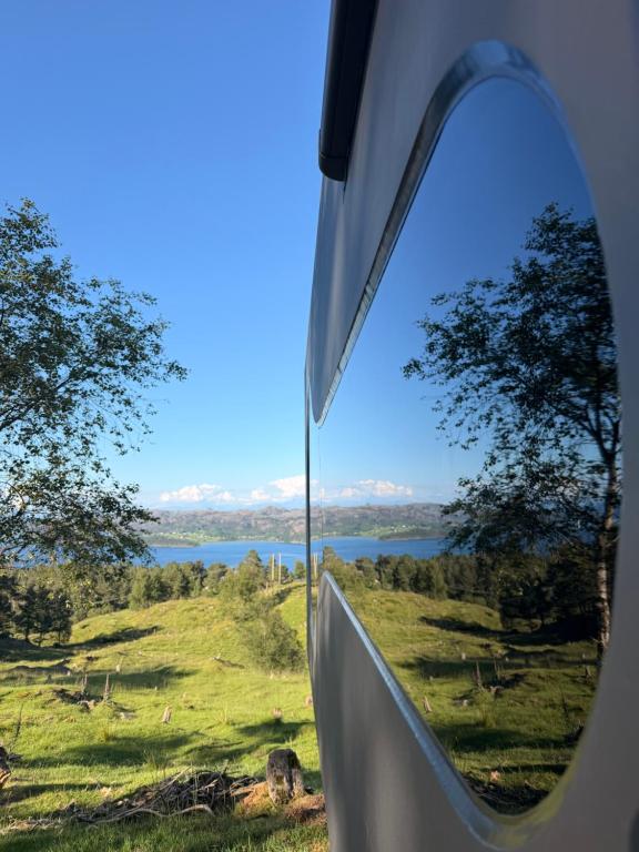 a view from the inside of a tent looking out at a lake at Birdbox Forland in Stord