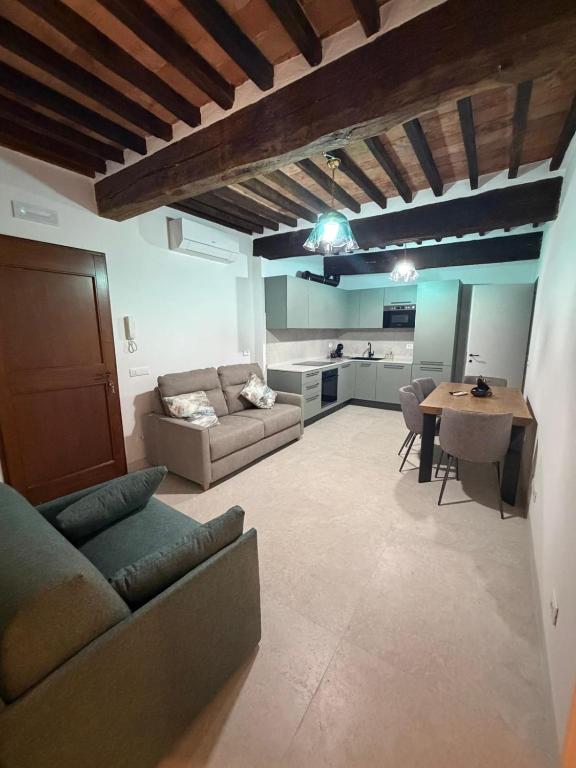 a living room with a couch and a table at b&b K2R in Chiusdino