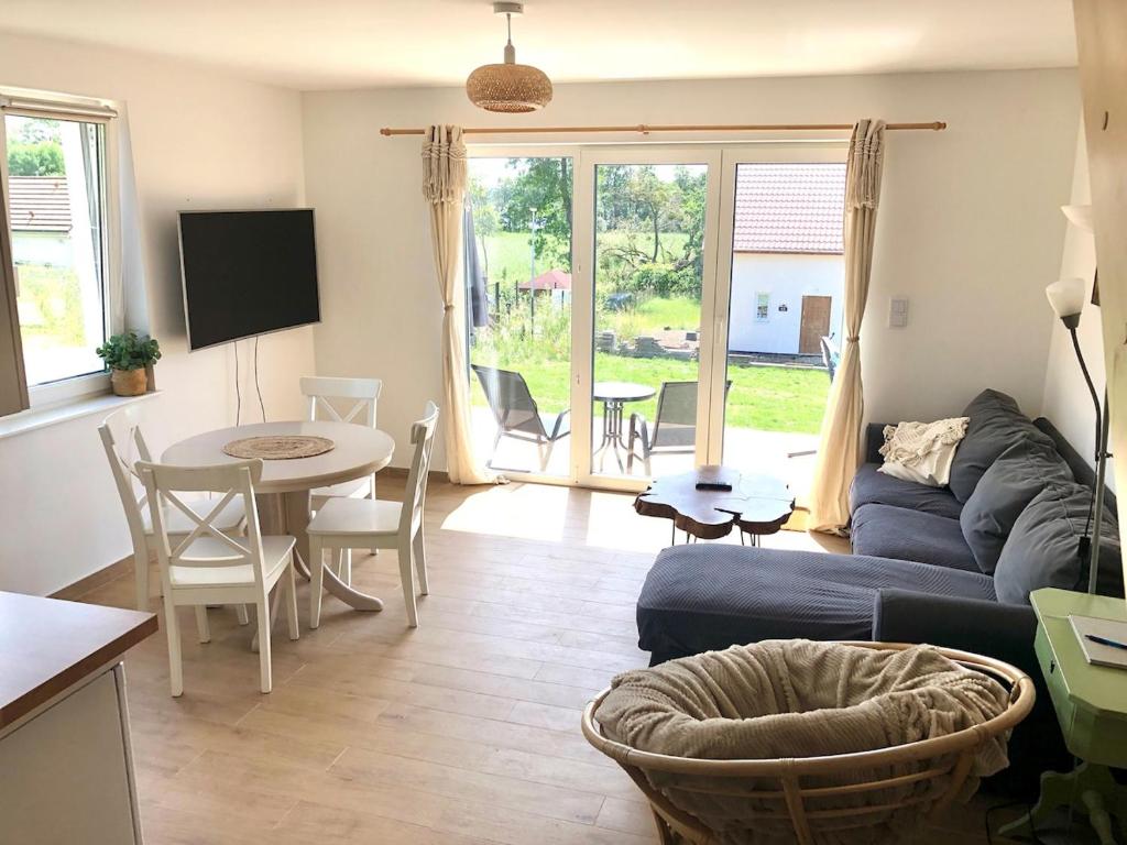 a living room with a couch and a table at Lake House Moryn in Przyjezierze