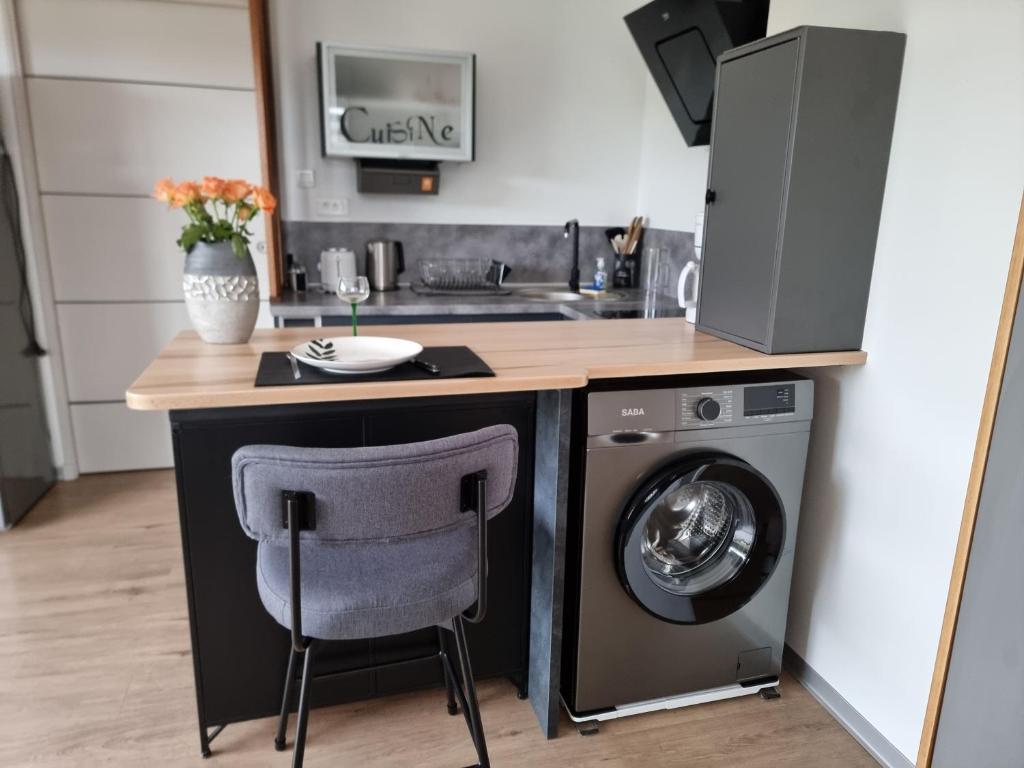 a kitchen with a counter and a washing machine at TY Nid in Lannion