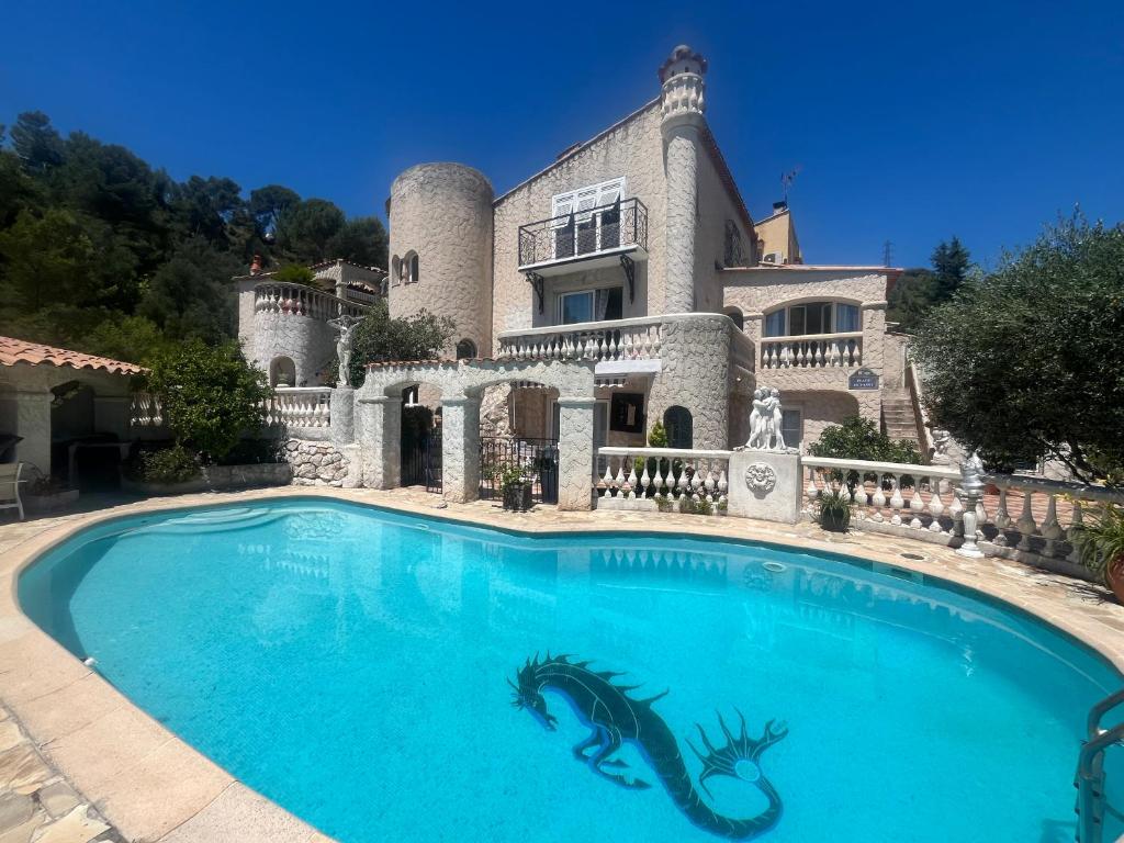 a large swimming pool in front of a house at Chez Antoinette et Jo in Drap