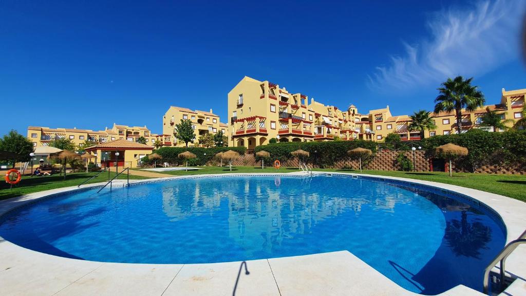 a large swimming pool in front of a building at Sun And Moon in Ayamonte