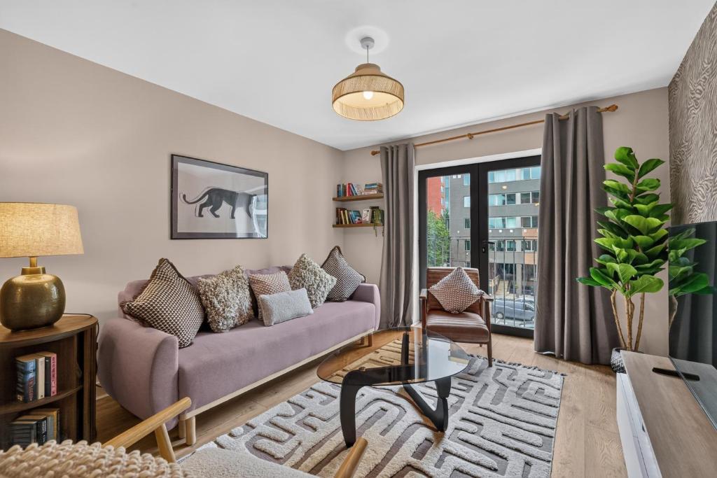 a living room with a couch and a window at Central Belfast Apartments: Citygate in Belfast