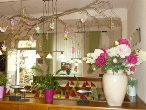 a vase of flowers on a counter in a store at Hotel & Gasthaus Forelle in Thale