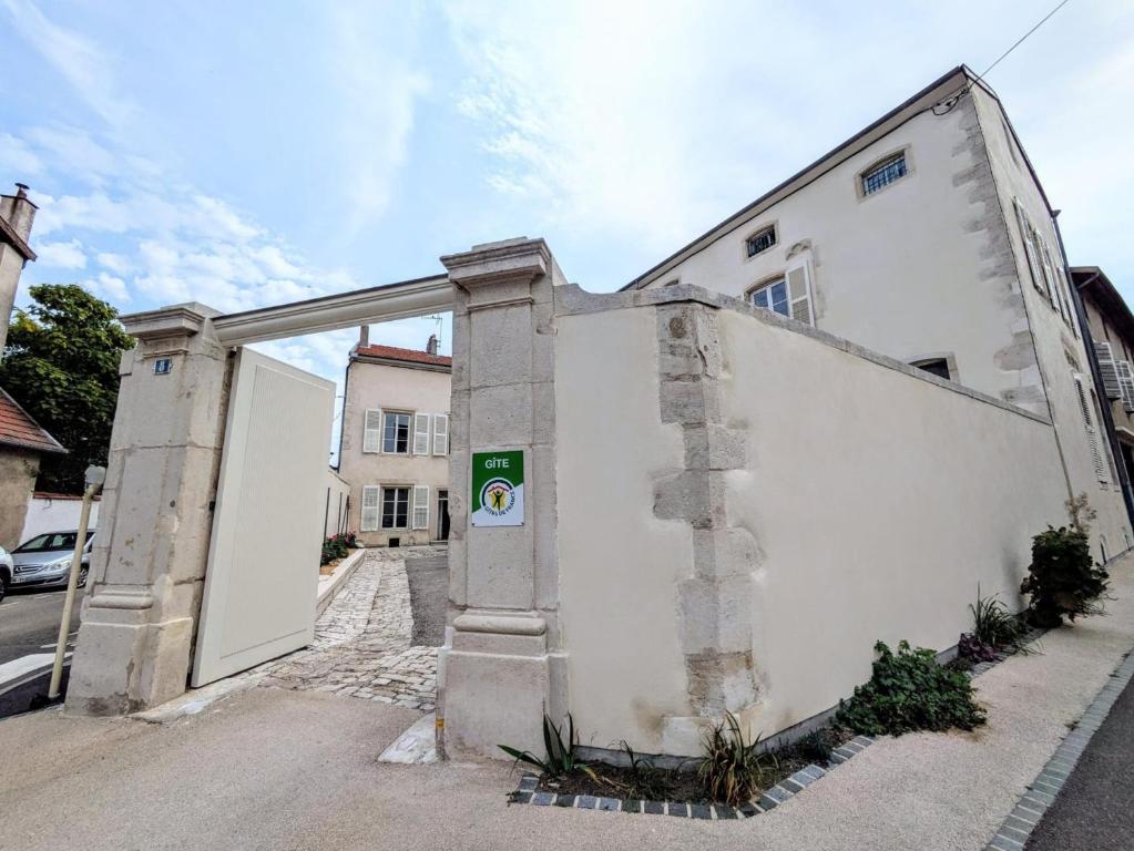 a white building with an open door on a street at maison des chanoines in Toul