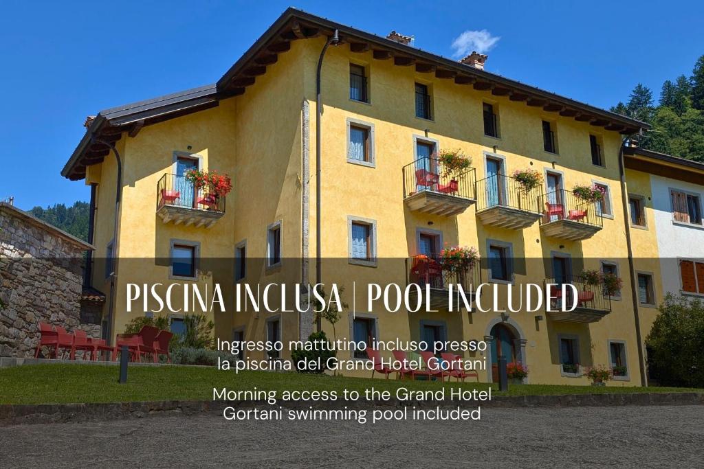 a building with a sign in front of it at Residence Samont - Borgo Gortani in Arta Terme
