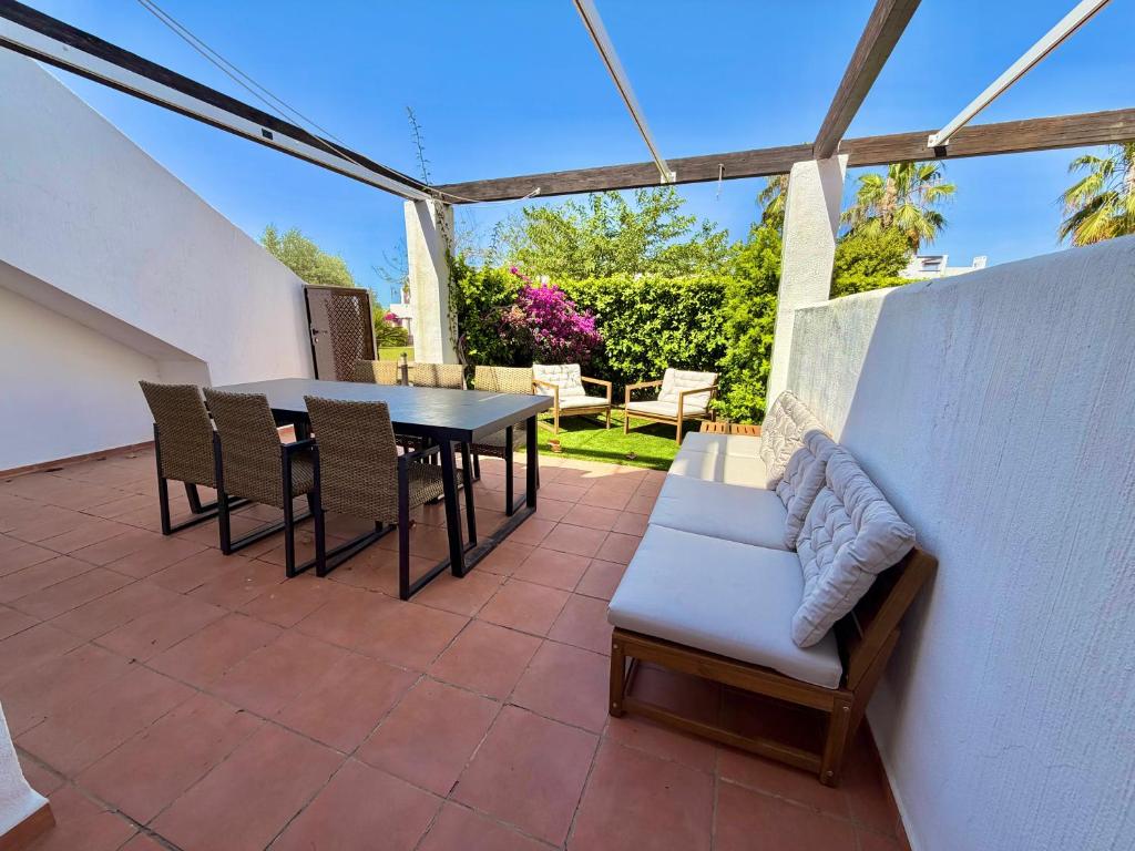 a patio with a table and chairs on a patio at Condado de Alhama 5 SV29 in Alhama de Murcia