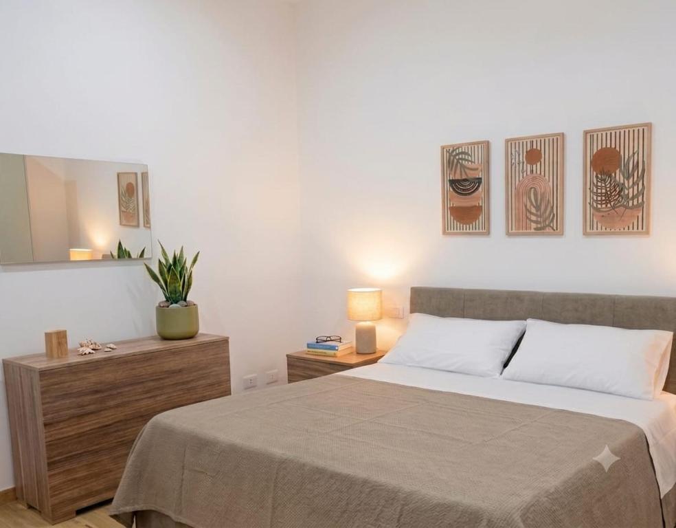 a bedroom with a large bed and a mirror at Appartamenti Del Pesco in Trapani