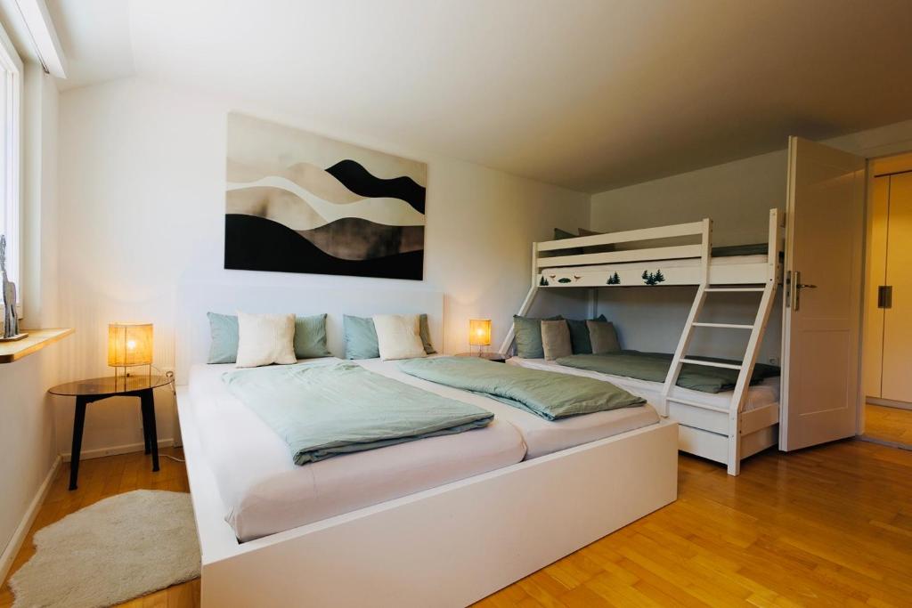a bedroom with two bunk beds and a ladder at Ferienwohnung Fuchsfelsen, perfekt für Familien mit Kindern in Häusern