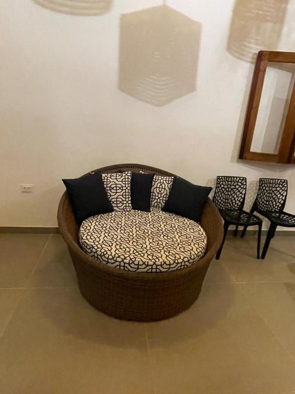 a chair sitting in a room with two chairs at Sumar your beach house in Japaratinga in Japaratinga