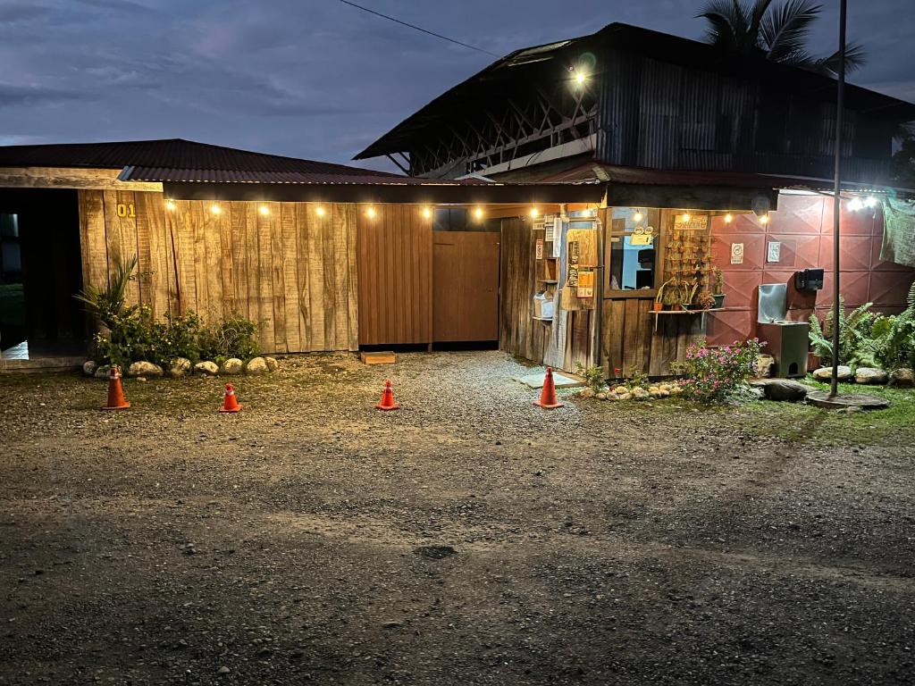 a house with lights on the side of it at Hospedaje Las Cabañas in Batán