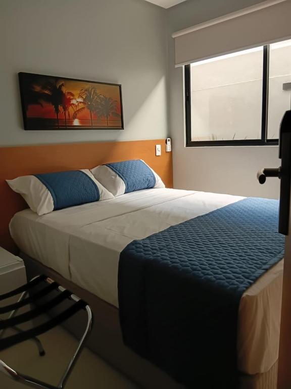 a bedroom with a large bed and a window at The Hotel in Teresina