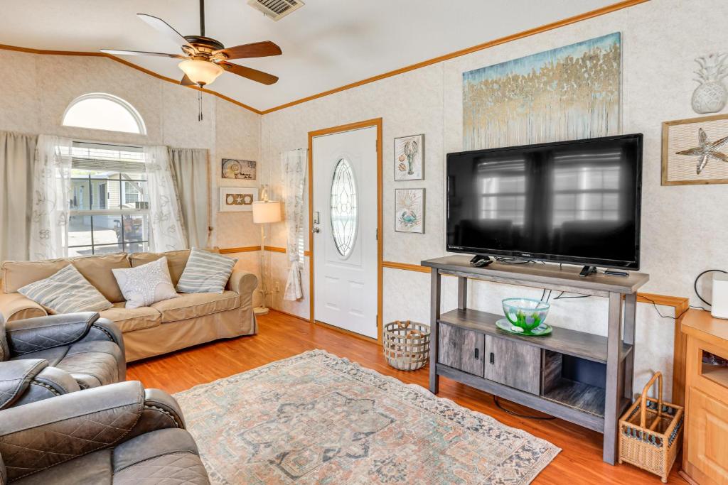 a living room with a large flat screen tv at Pool + Dock Access! Boater’s Base in Lake Placid in Lake Placid