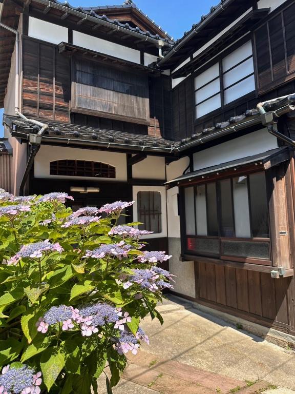 a house with purple flowers in front of it at Kanazawa Machiya Kasaichi - Entire House Free Parking in Kanazawa