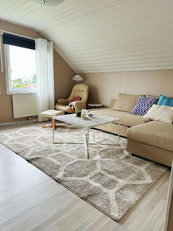 a living room with a couch and a table at Centralt och havsnära på Stensö in Kalmar