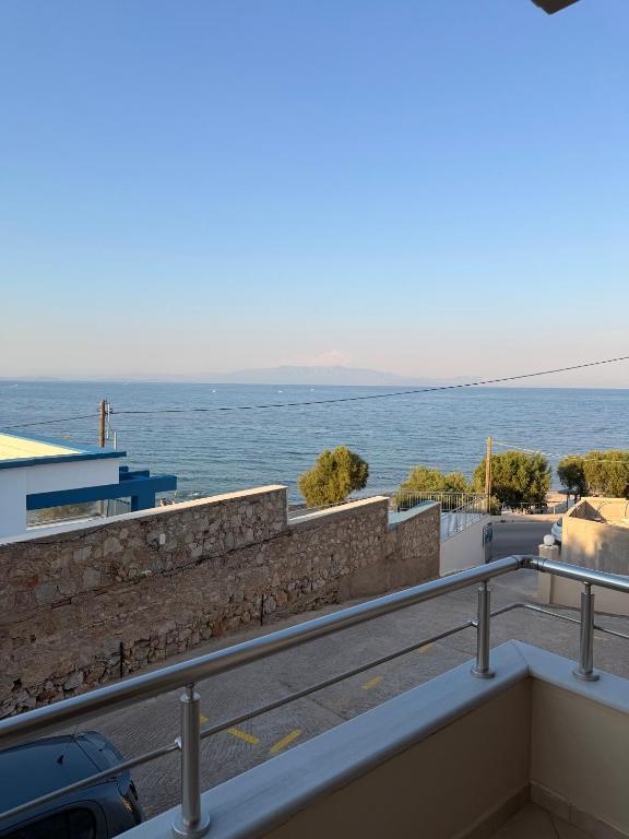 a view of the ocean from a balcony at Geomelos Theodoros Apartments in Chios