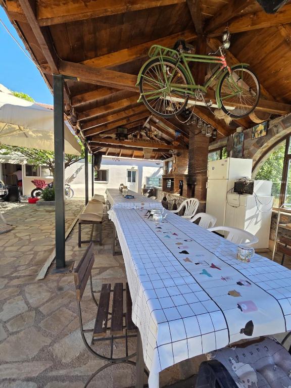 a long table with a bike hanging from the ceiling at Authentic Village House in Tourkolékas