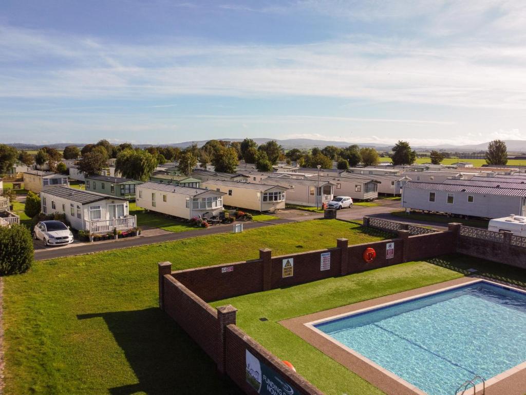 an aerial view of a property with a pool and a parking lot at Cockerham Sands Holiday Park in Cockerham