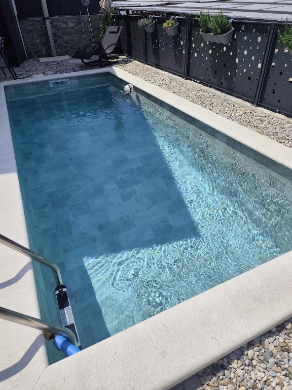 an empty swimming pool in a backyard with at Marina Seaside Escape in Malinska