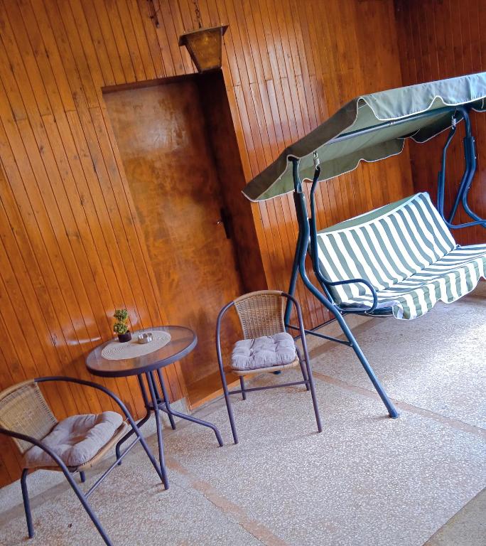 a room with chairs and a table and a bench at APARTMAN MINnA in Kuršumlija