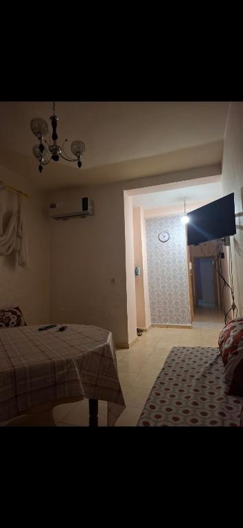a bedroom with a bed and a door with a window at شقق للكراء في سلوان in Selouane