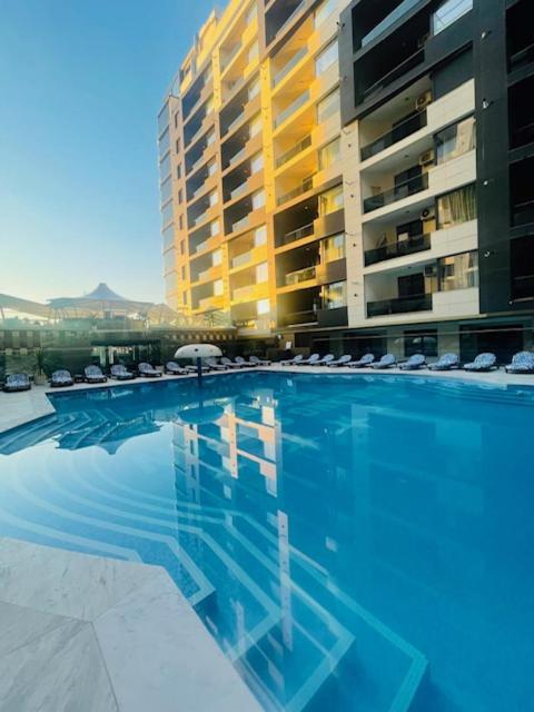 a large swimming pool in front of a building at VCV Apartments in Mamaia Sat/Năvodari