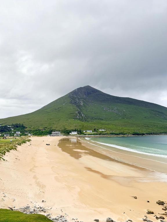 a view of a beach with a mountain in the background at The Strand, Dugort Achill in Achill