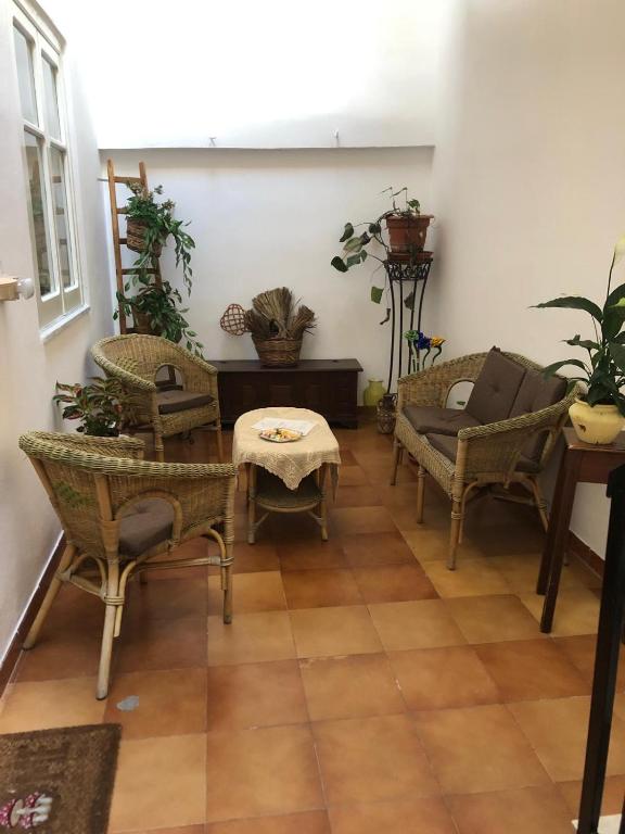 a living room with chairs and a table at Donna Teresa in Castelbuono