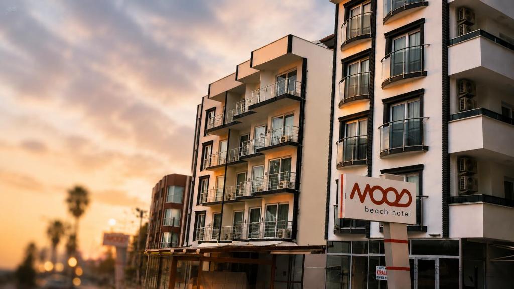 a building with a sign on the side of it at mood beach hotel in Didim