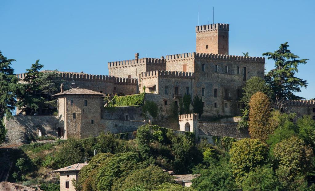 a castle on top of a hill with trees at Castello di Tabiano in Tabiano