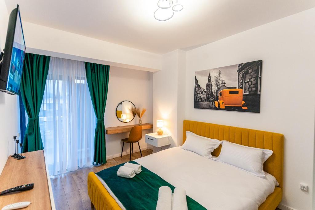 a hotel room with a bed and a desk and a bed at Apartament23 Sibiu in Şelimbăr