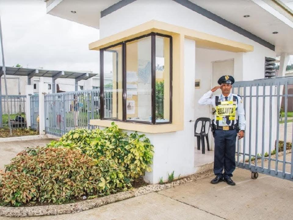 a police officer standing in front of a house at Rooms in Bloom in Tarlac