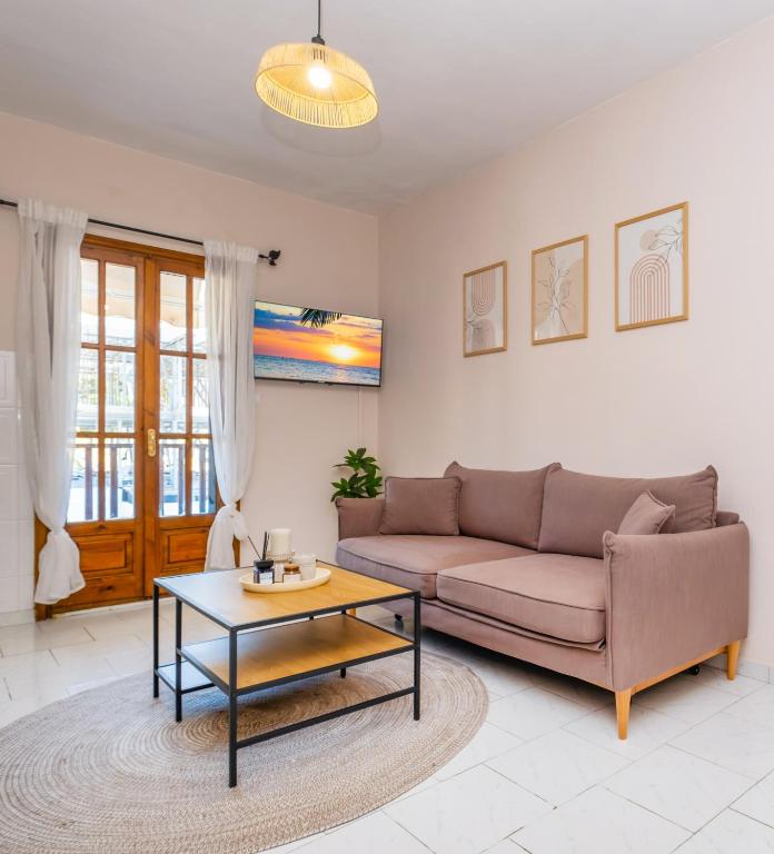a living room with a couch and a coffee table at Rocabella Home in Kriopigi