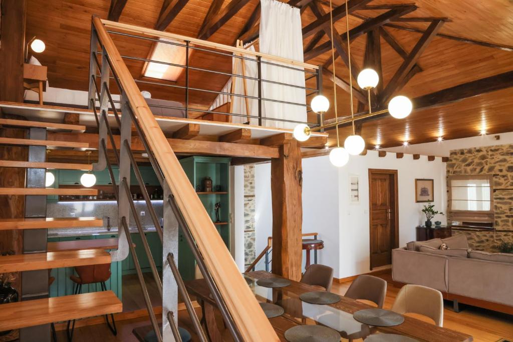 an open living room with a spiral staircase in a house at Elia City House in Kavála