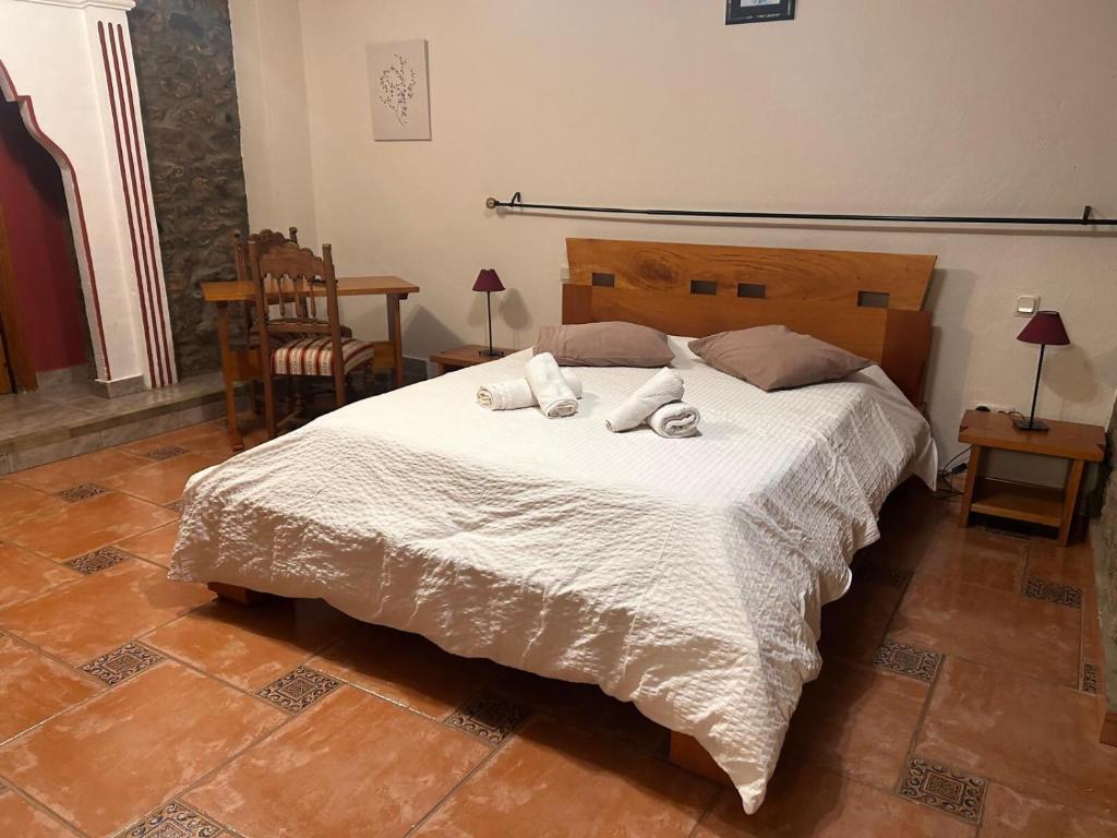 a bedroom with a bed with two towels on it at Casa Rural Villacampa (Nocito) in Nocito