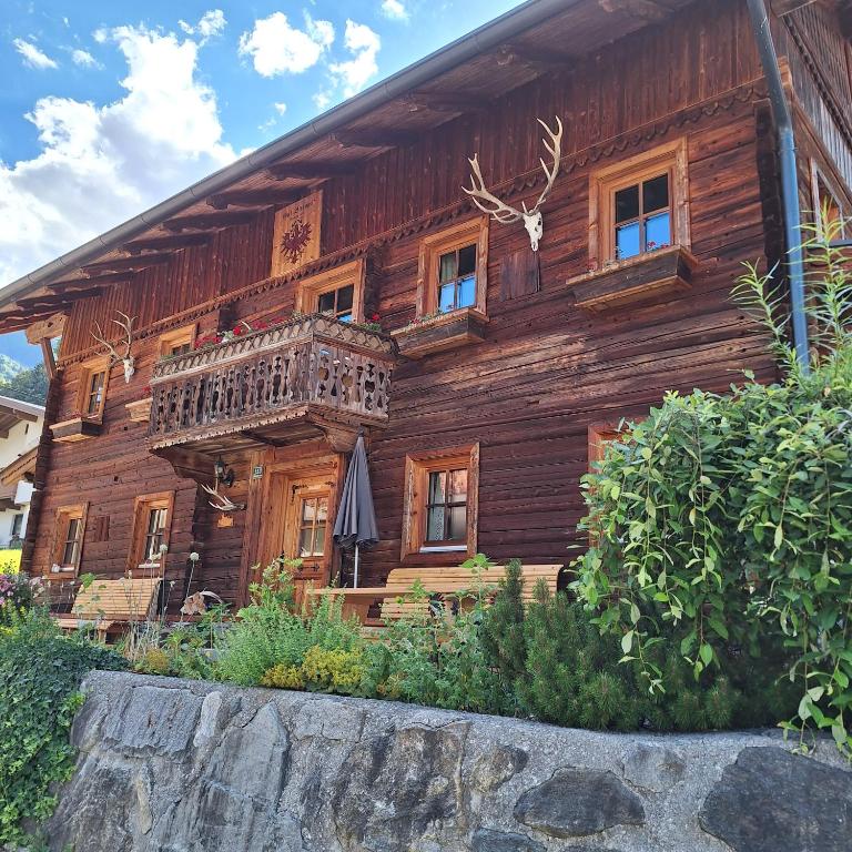 a wooden house with a balcony on the side of it at Haus Elfriede in Schwendau