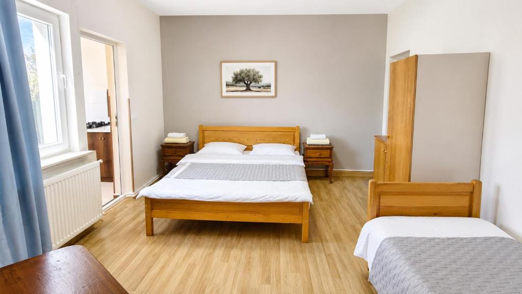 a bedroom with two beds and two windows at Tuz House R5 in Bakuriani