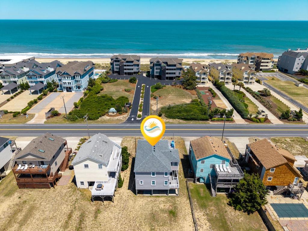 an aerial view of a neighborhood with houses and a road at 5070 - Sandy Bottoms in Kill Devil Hills