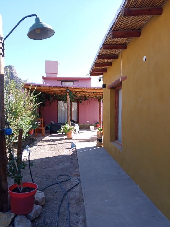 a building with a street light next to a house at Cabaña Samka in Maimará