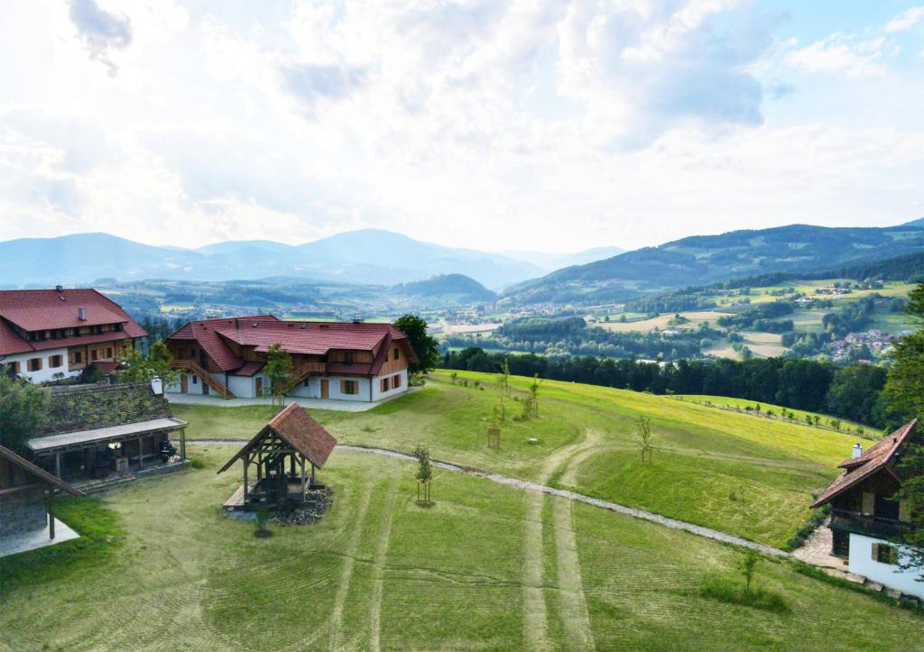 an aerial view of a farm with mountains in the background at Dazumahl schafft besondere Augenblicke für Genießer im naturnahen Private Hideaway in der Oststeiermark in Puch bei Weiz