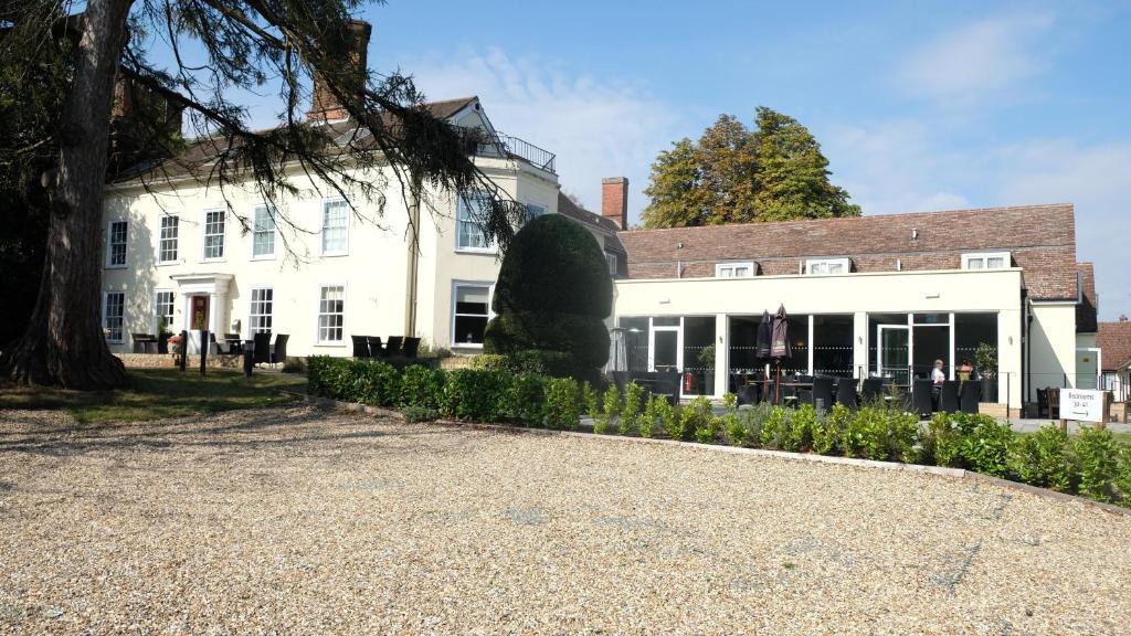 a large white house with people standing in front of it at Best Western Priory Hotel in Bury Saint Edmunds